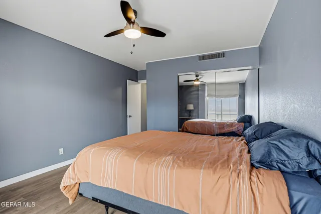 a living room with furniture a flat screen tv and kitchen view
