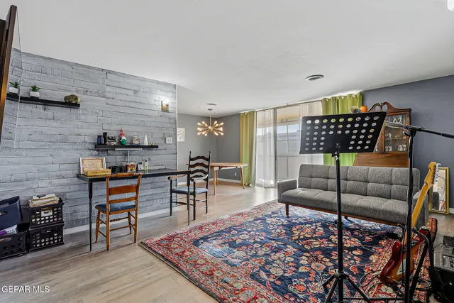 a view of a dining room with furniture and a chandelier