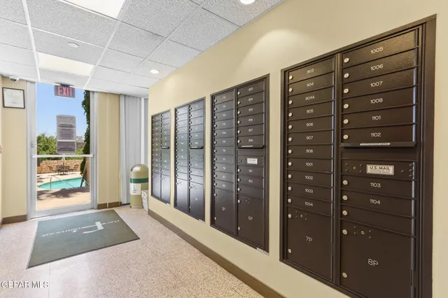 a patio with table and chairs and potted plants