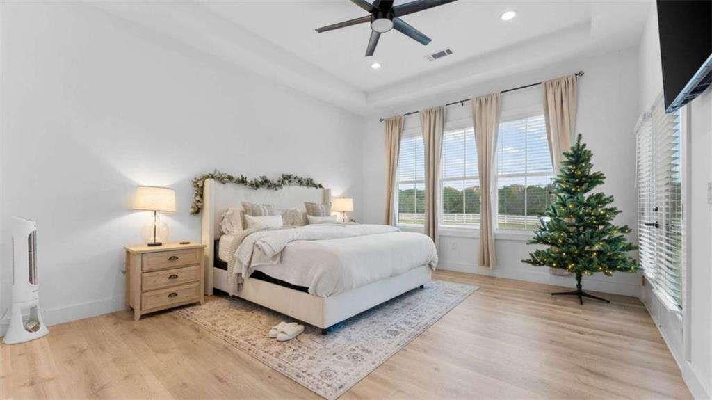 28 Ravenfield Road Taylorsville, GA 30178 - Photo 15 of 38 a spacious bedroom with a large bed and a potted plant