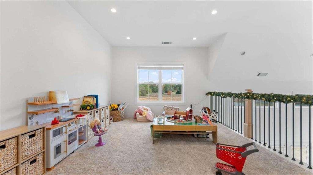 28 Ravenfield Road Taylorsville, GA 30178 - Photo 22 of 38 a living room with furniture and a book shelf