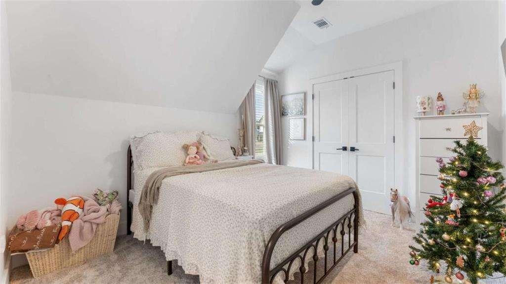 28 Ravenfield Road Taylorsville, GA 30178 - Photo 25 of 38 a bedroom with a bed and a potted plant