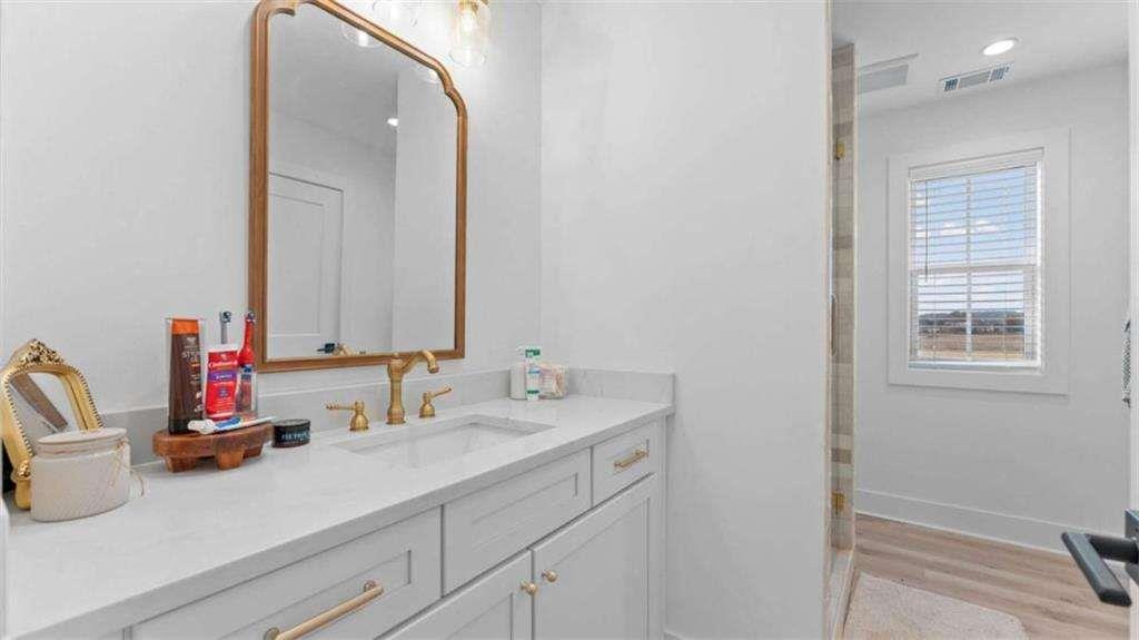 28 Ravenfield Road Taylorsville, GA 30178 - Photo 27 of 38 a bathroom with a sink and a mirror