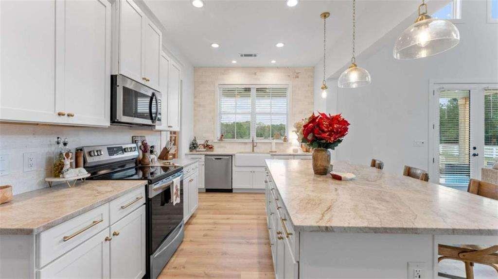 28 Ravenfield Road Taylorsville, GA 30178 - Photo 10 of 38 a kitchen with granite countertop a sink cabinets and stainless steel appliances