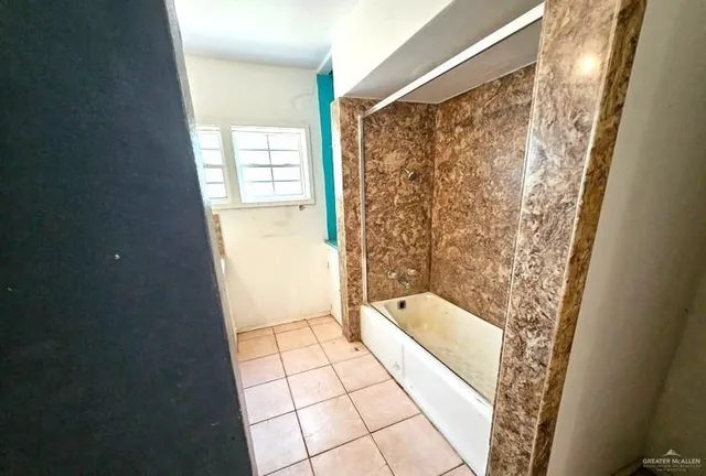 a bathroom with a bathtub and shower