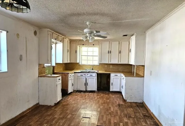 a kitchen with a refrigerator and a stove top oven