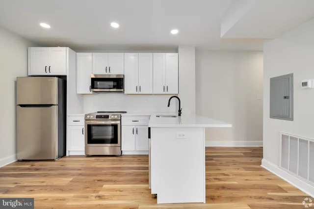 a kitchen with stainless steel appliances a refrigerator stove microwave and sink