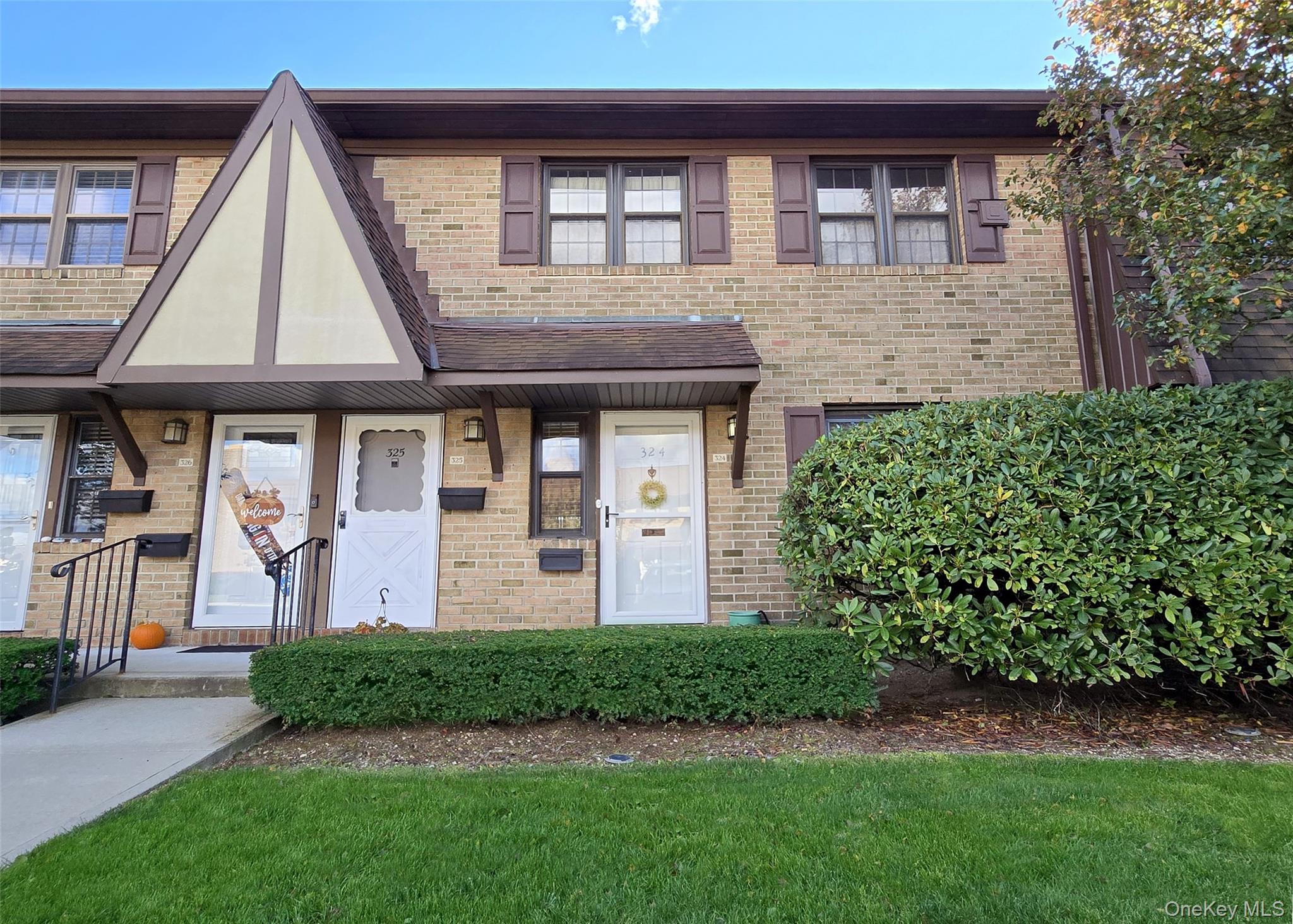 a front view of a house with a garden