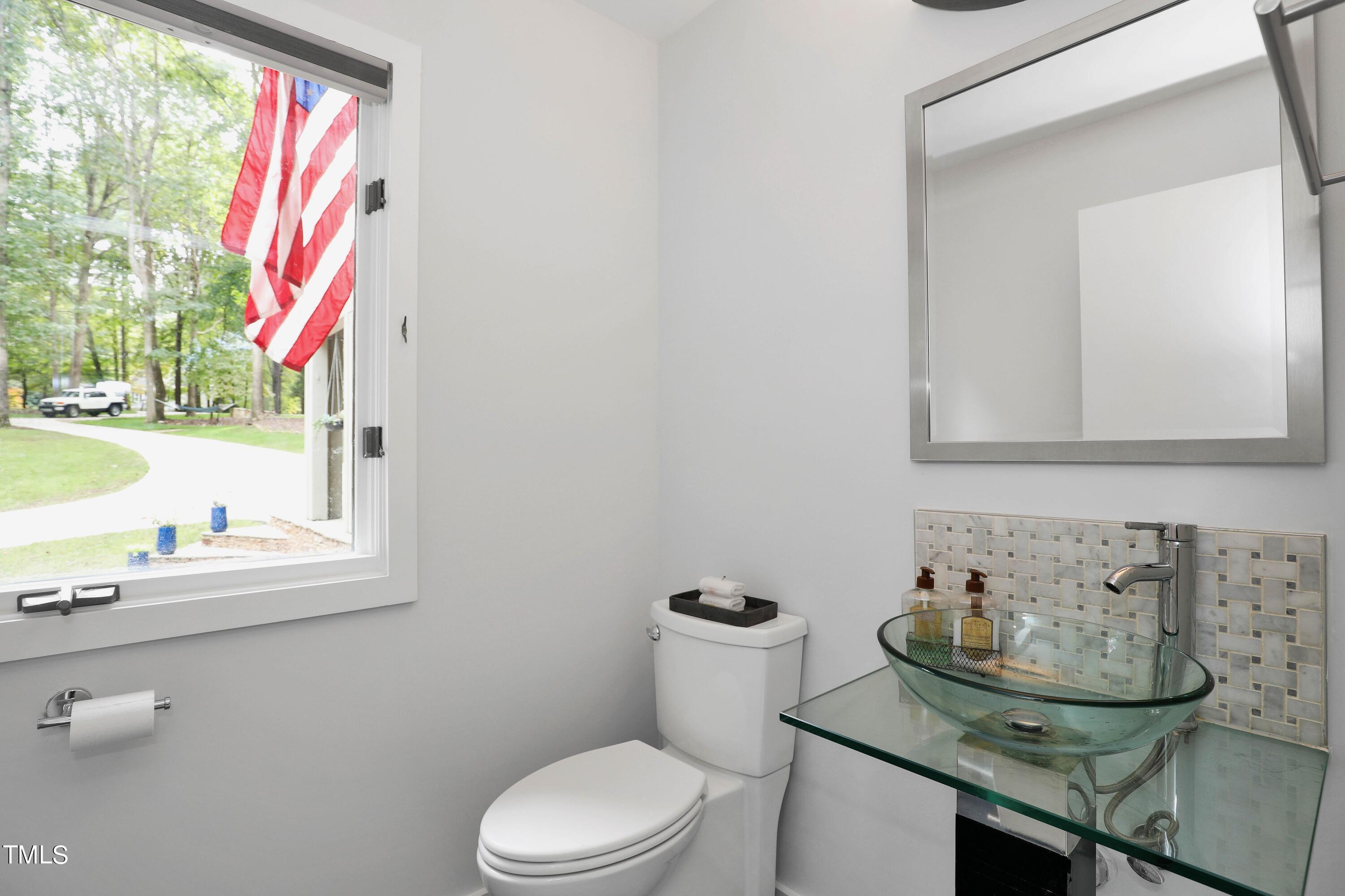 11312 Old Creedmoor Road Raleigh, NC 27613 - Photo 30 of 62 a bathroom with a sink and a mirror