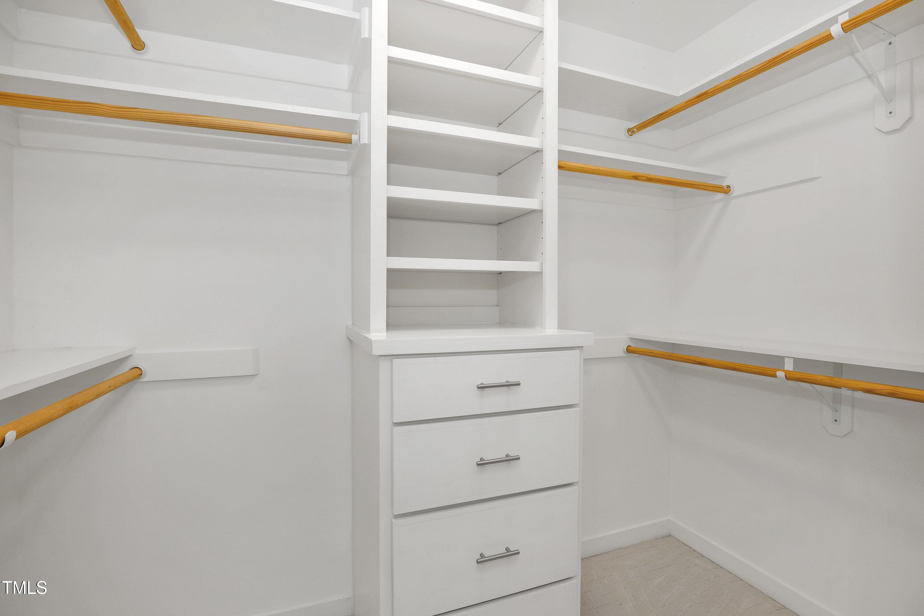 11312 Old Creedmoor Road Raleigh, NC 27613 - Photo 43 of 62 a view of walk in closet with empty racks