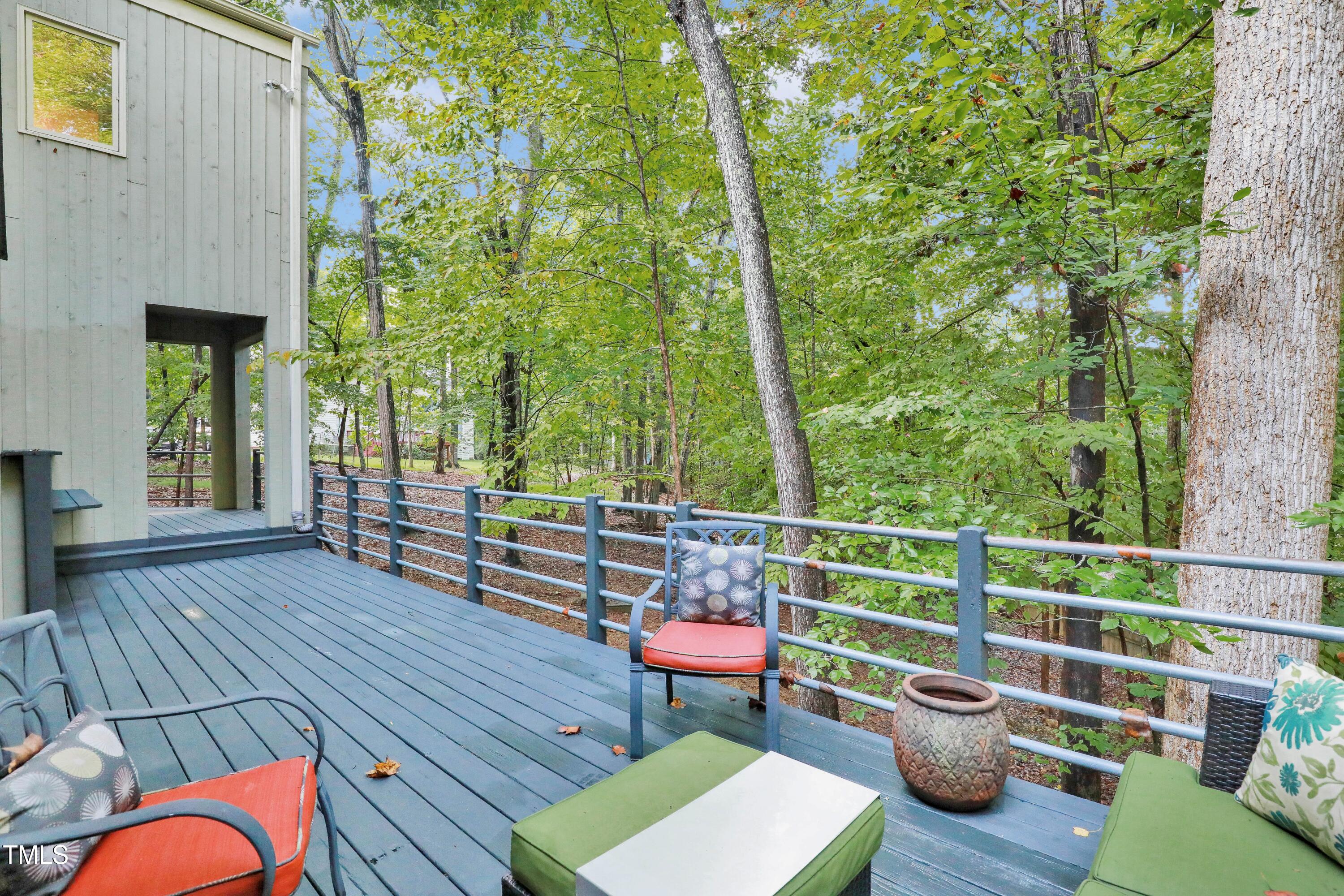 11312 Old Creedmoor Road Raleigh, NC 27613 - Photo 60 of 62 a view of a deck with couches table and chairs with wooden floor and fence