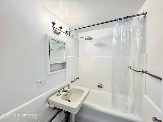 a view of a room with wooden floor and entryway
