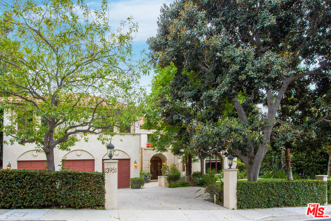 13951 Durham Road Beverly Hills, CA 90210 - Photo 2 of 29 a view of a white house with a tree and plants