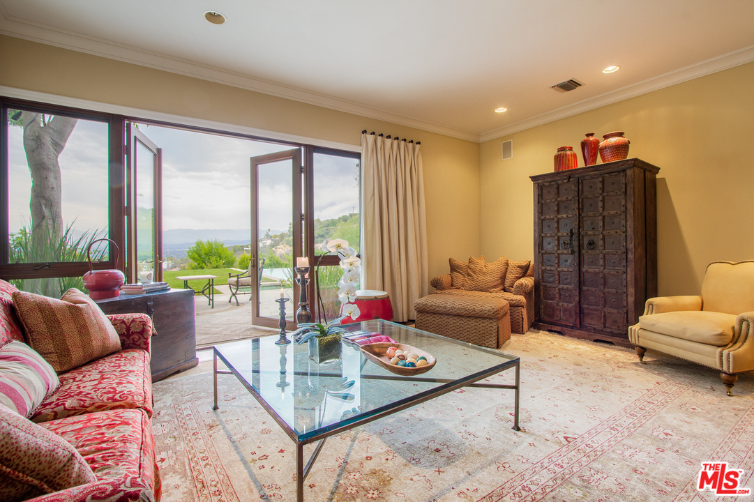 13951 Durham Road Beverly Hills, CA 90210 - Photo 11 of 29 a living room with furniture and a large window