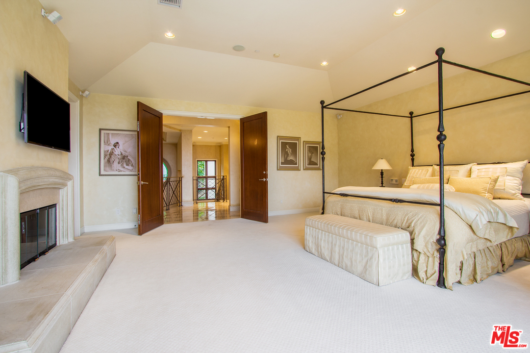 13951 Durham Road Beverly Hills, CA 90210 - Photo 15 of 29 a bedroom with a bed and a flat screen tv