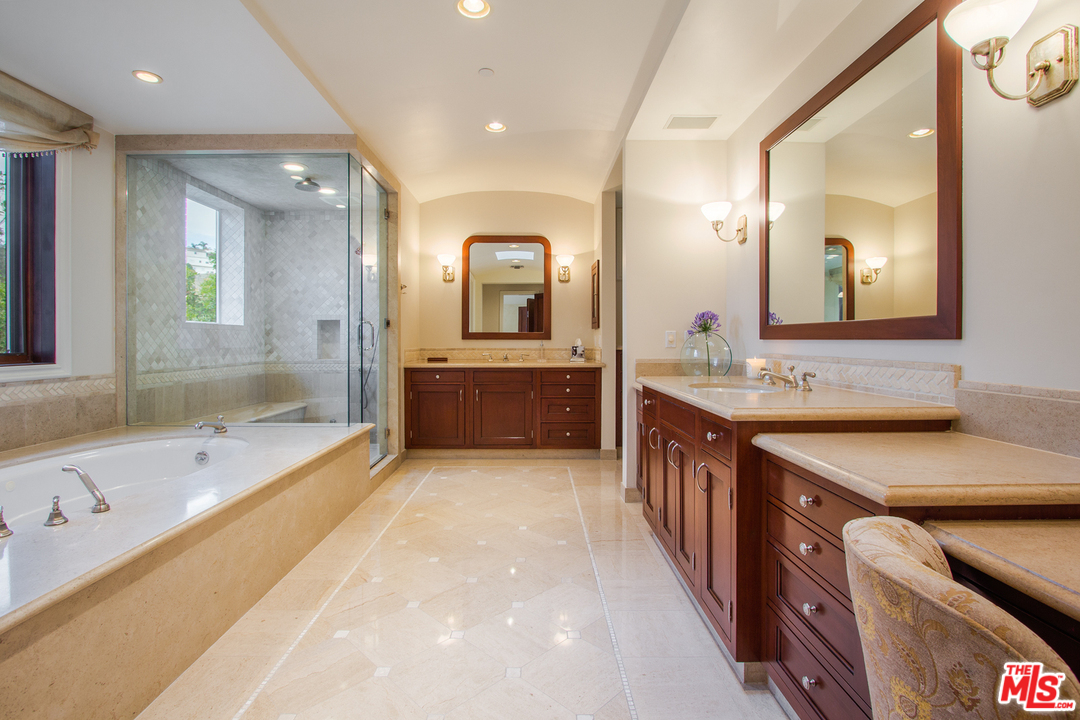 13951 Durham Road Beverly Hills, CA 90210 - Photo 16 of 29 a large bathroom with a large tub double vanity sink and a mirror