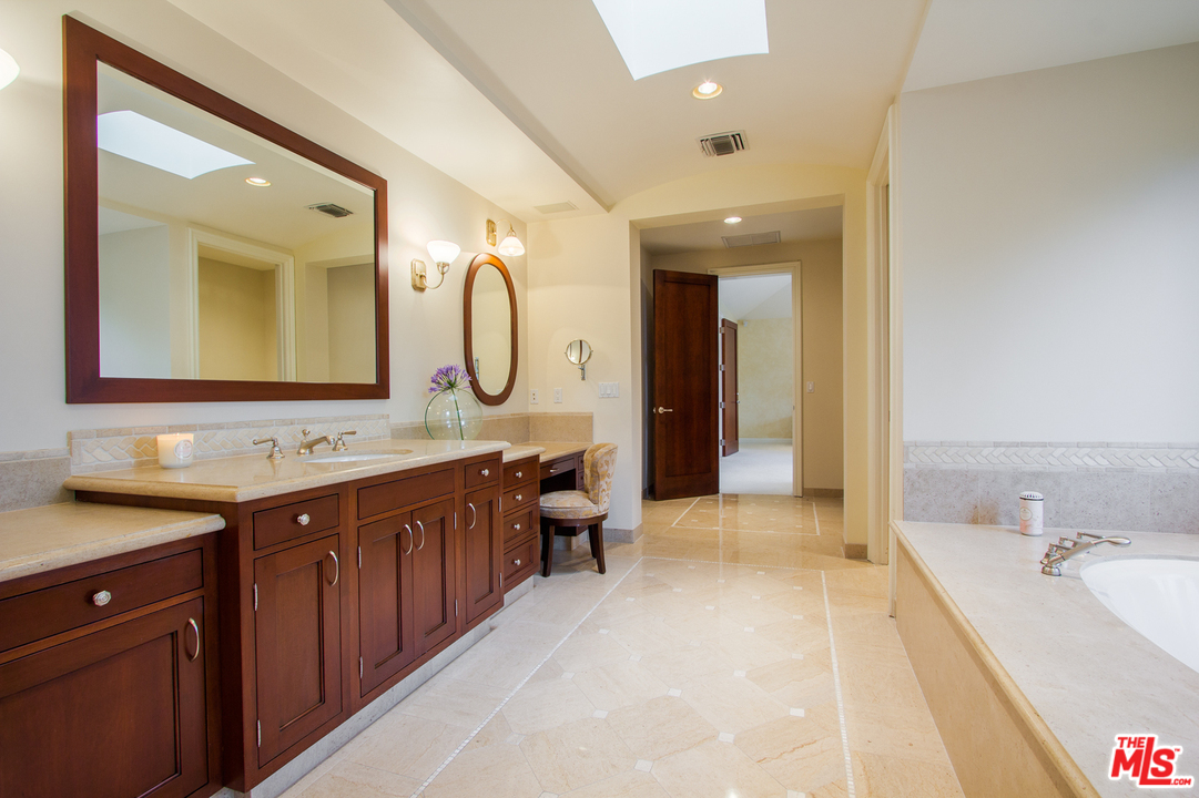 13951 Durham Road Beverly Hills, CA 90210 - Photo 18 of 29 a spacious bathroom with a double vanity sink mirror and bathtub