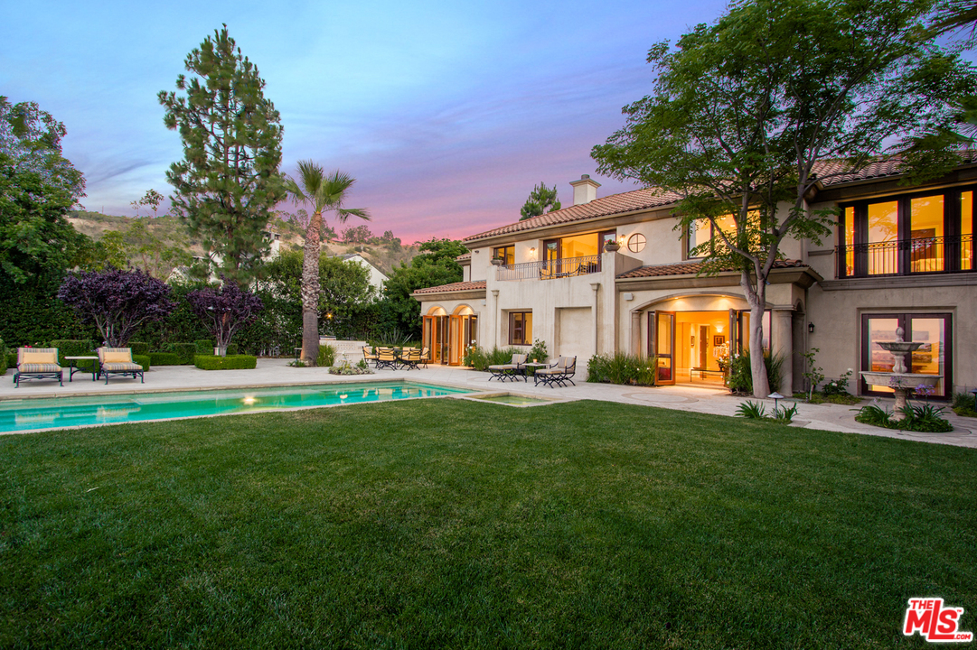 13951 Durham Road Beverly Hills, CA 90210 - Photo 23 of 29 a view of a house with a big yard and a large tree