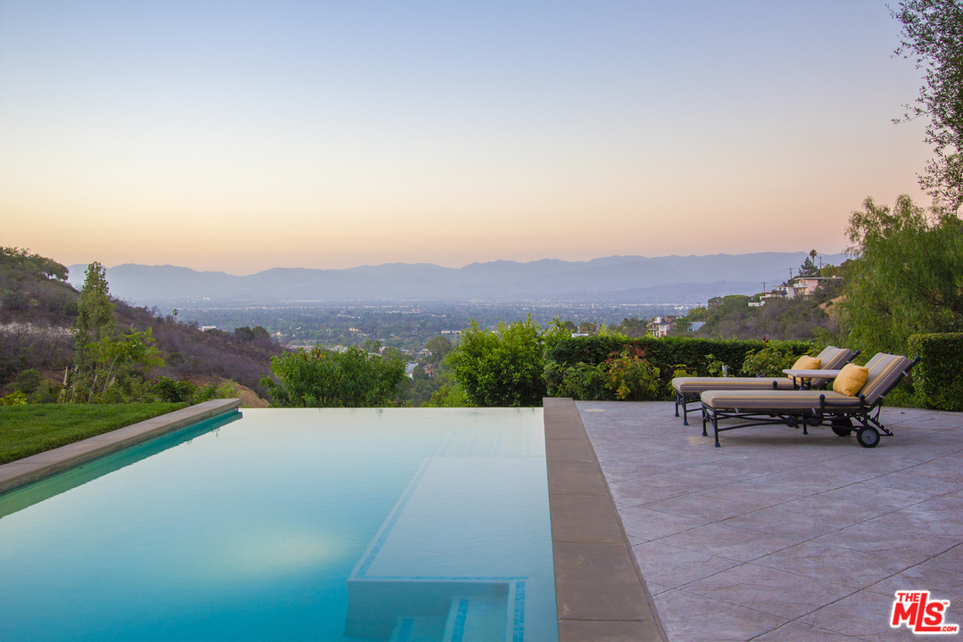 13951 Durham Road Beverly Hills, CA 90210 - Photo 25 of 29 a view of a terrace with a bench