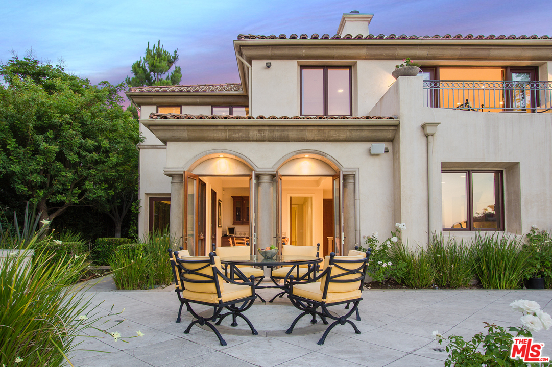 13951 Durham Road Beverly Hills, CA 90210 - Photo 26 of 29 a view of a house with a chairs and table in a patio