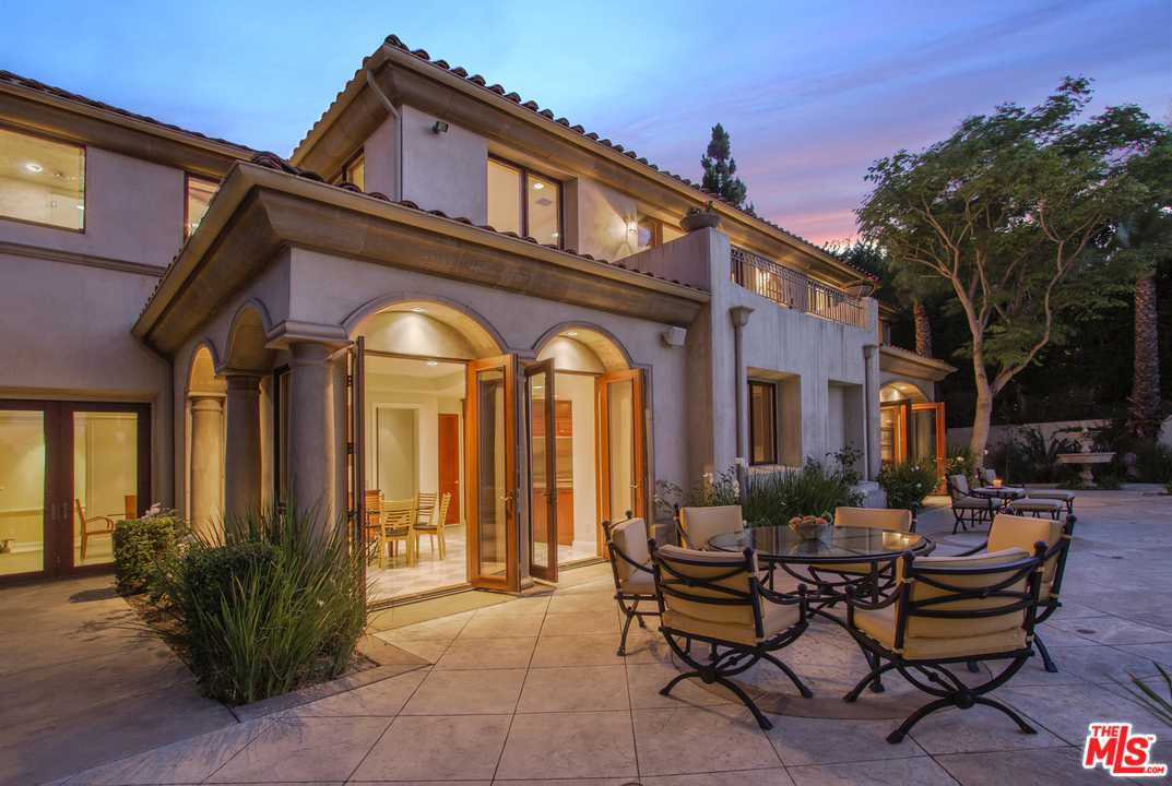 13951 Durham Road Beverly Hills, CA 90210 - Photo 29 of 29 a view of a house with a chairs and table in a patio