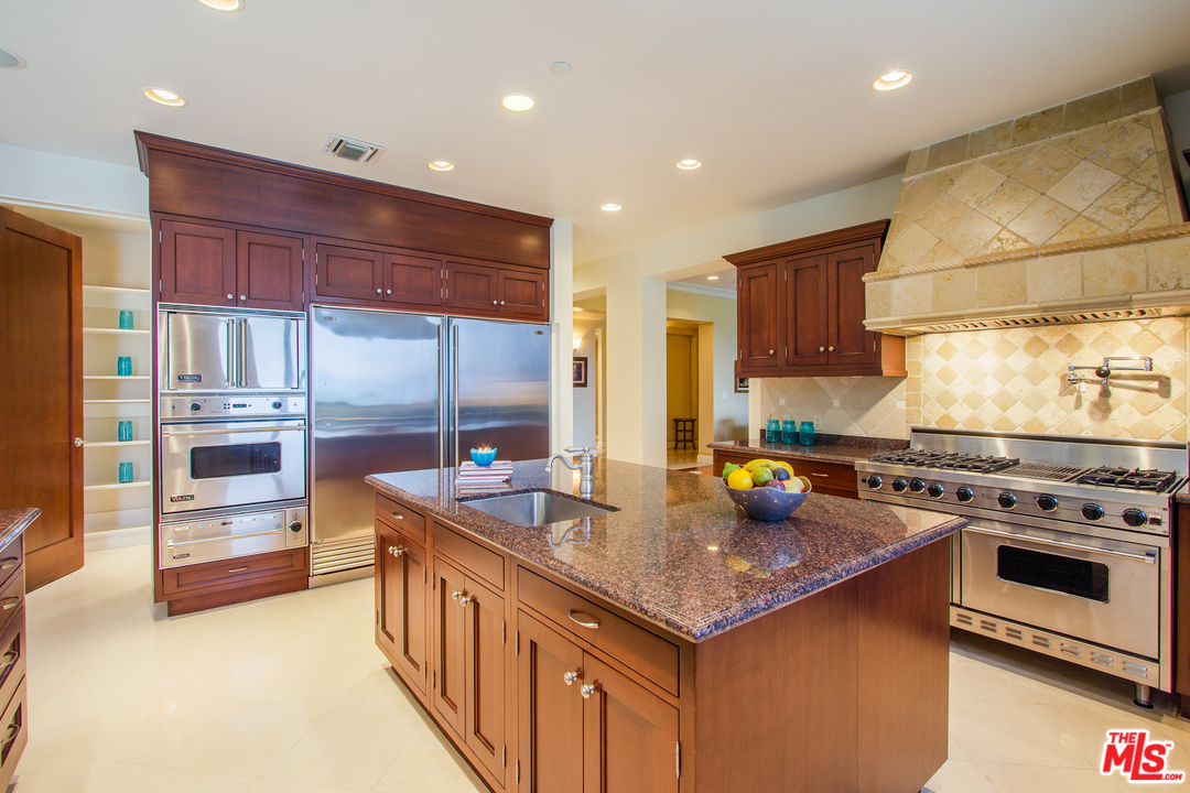 13951 Durham Road Beverly Hills, CA 90210 - Photo 8 of 29 a kitchen with stainless steel appliances granite countertop a stove a sink and a microwave