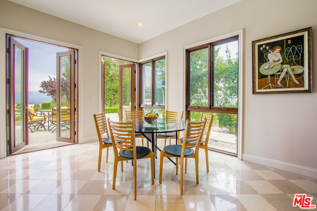 13951 Durham Road Beverly Hills, CA 90210 - Photo 9 of 29 a view of a dining room with furniture large windows and wooden floor