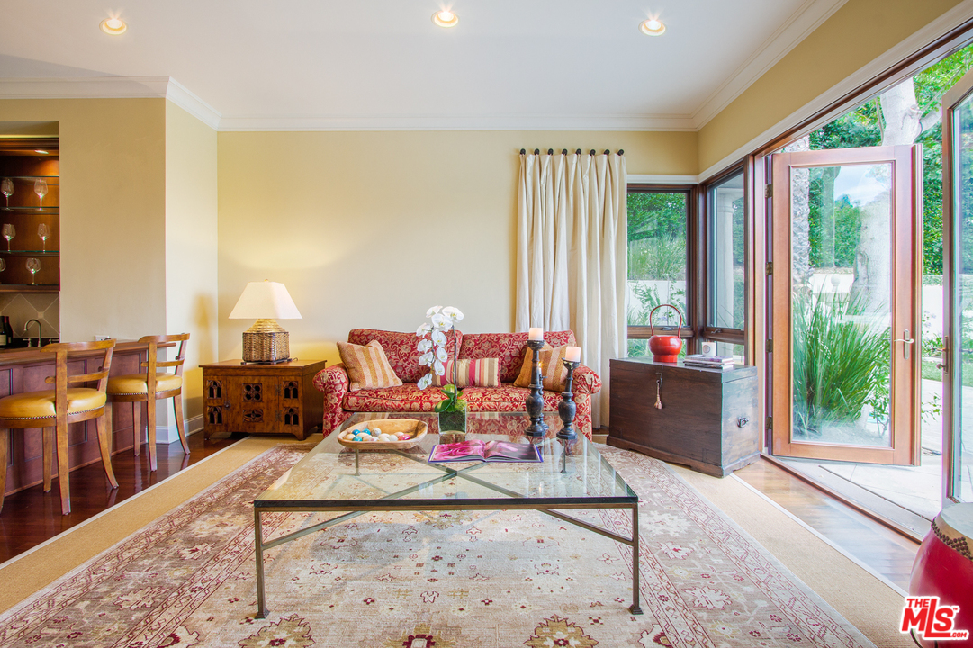 13951 Durham Road Beverly Hills, CA 90210 - Photo 10 of 29 a living room with furniture and large windows