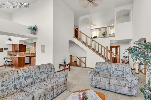 a living room with furniture and a dining table