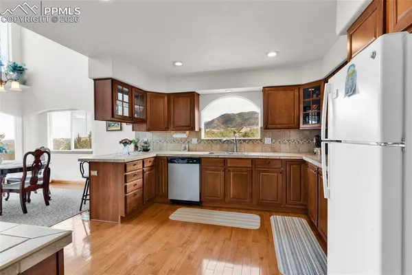 a kitchen with stainless steel appliances granite countertop a refrigerator sink and cabinets