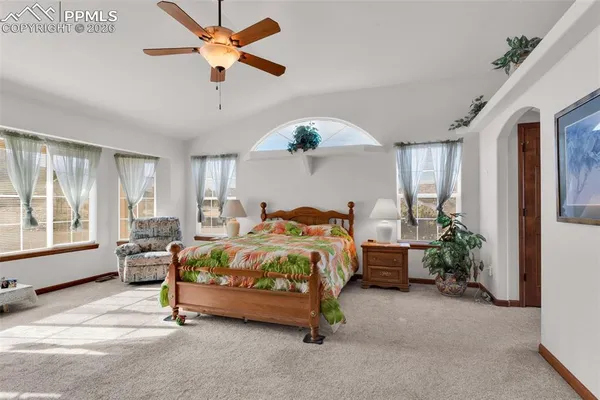 a bedroom with a bed and ceiling fan