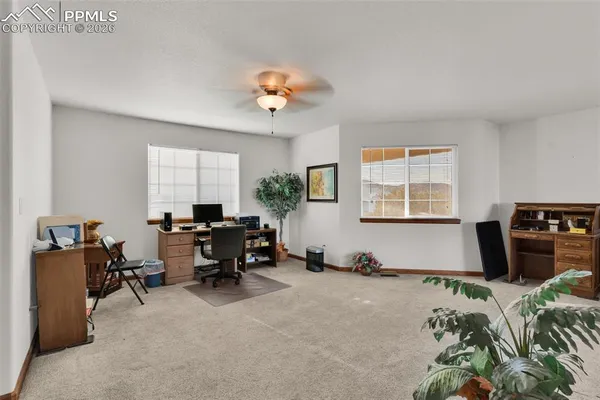 a view of a livingroom with furniture and a window