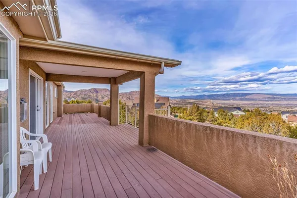 an aerial view of a house with a yard and a mountain
