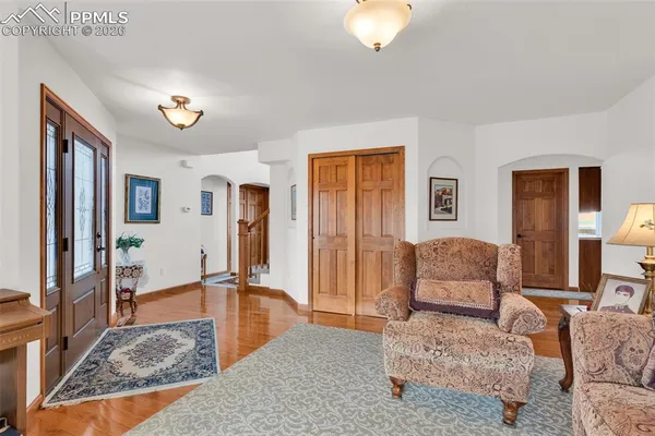 a living room with furniture rug and a table