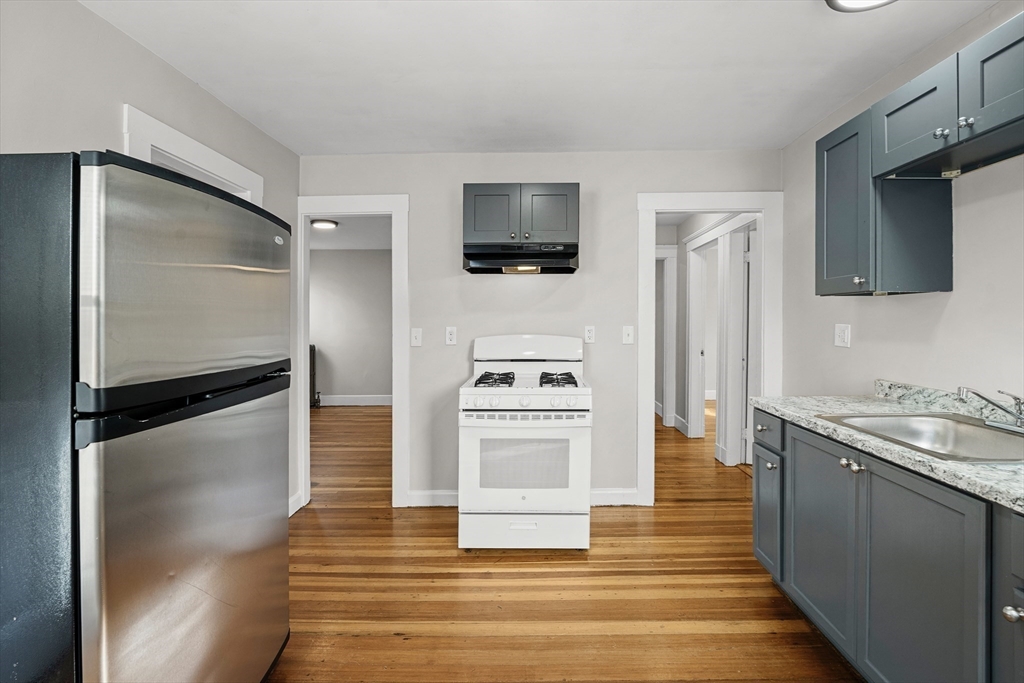 a kitchen with stainless steel appliances a refrigerator stove and microwave