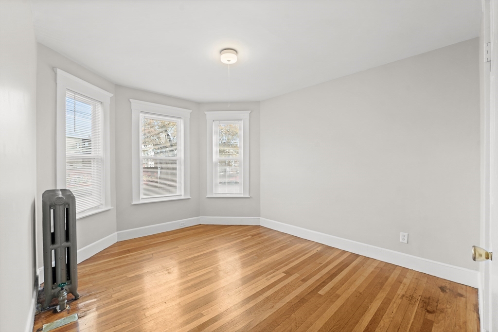 40 Ripley Road, Unit 2 Boston, MA 02124 - Photo 11 of 34 a view of empty room with wooden floor and fan