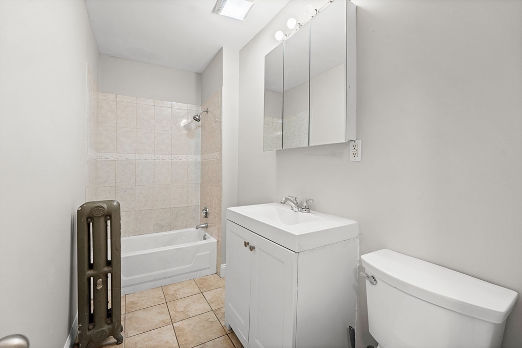 40 Ripley Road, Unit 2 Boston, MA 02124 - Photo 12 of 34 a bathroom with a sink a toilet and bathtub