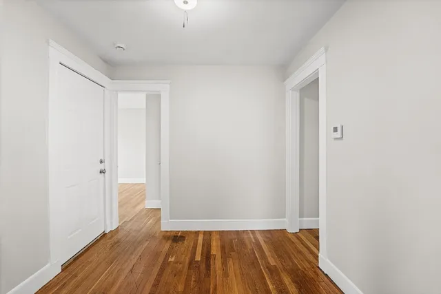 a view of a room with wooden floor and a sink