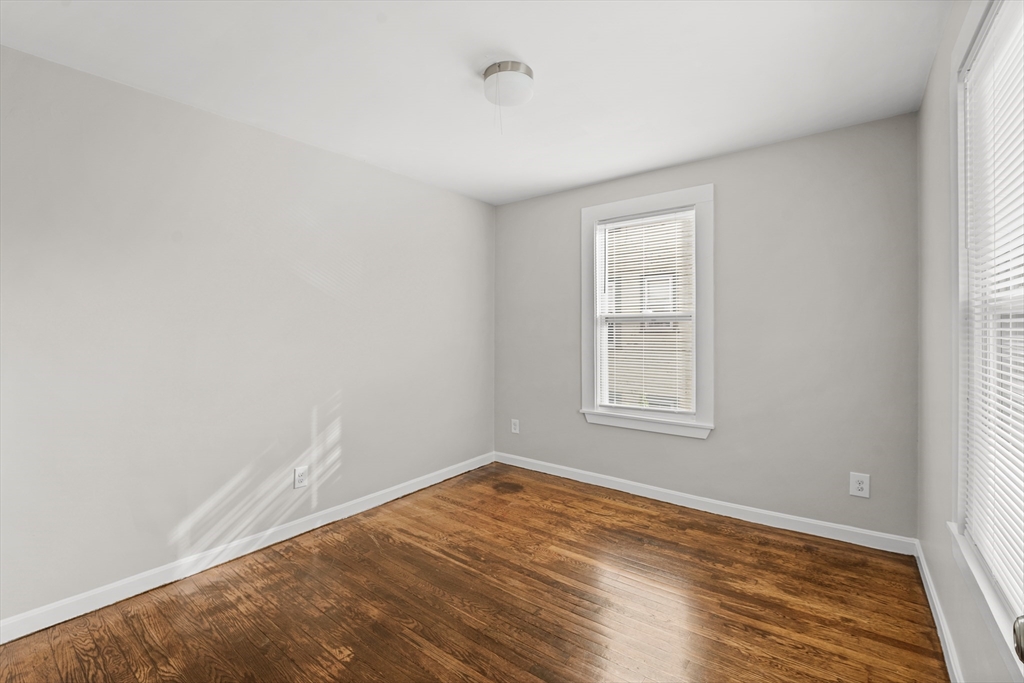 40 Ripley Road, Unit 2 Boston, MA 02124 - Photo 27 of 34 wooden floor in an empty room with a window