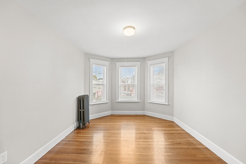 40 Ripley Road, Unit 2 Boston, MA 02124 - Photo 7 of 34 a view of empty room with wooden floor and fan