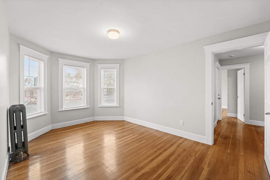 40 Ripley Road, Unit 2 Boston, MA 02124 - Photo 9 of 34 a view of empty room with wooden floor and fan