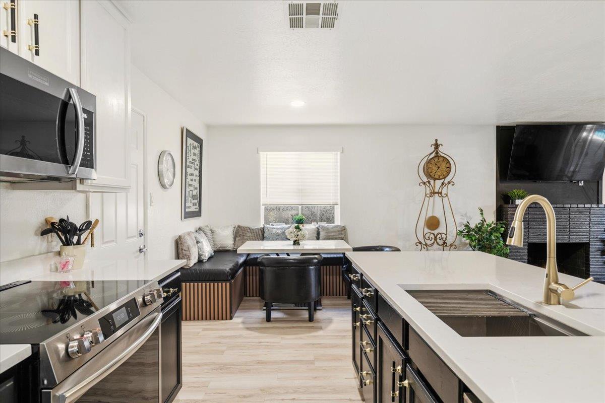 5844 Sharps Circle Carmichael, CA 95608 - Photo 1 of 1 a kitchen with granite countertop a sink and a stove top oven