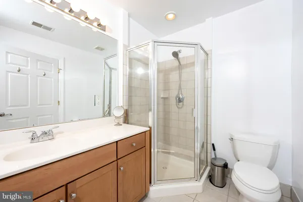 a bathroom with a sink toilet vanity and shower