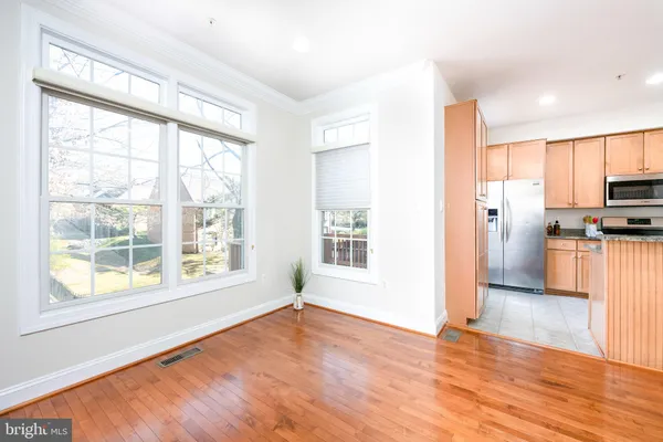 a view of a kitchen with a stove cabinets and wooden floor