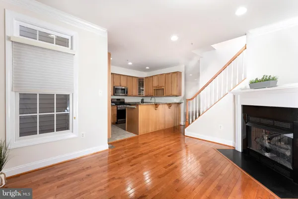 a view of a kitchen with wooden floor and electronic appliances