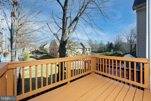 a balcony with wooden floor and fence