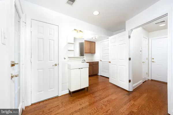 a view of a kitchen with white cabinets and white appliances