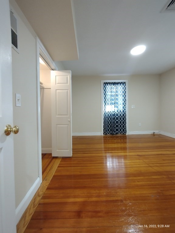 62 Washington Street, Unit 62 Wellesley, MA 02481 - Photo 12 of 18 a view of empty room with wooden floor and fan