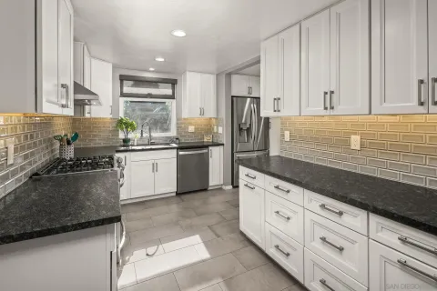 a kitchen with cabinets and stainless steel appliances