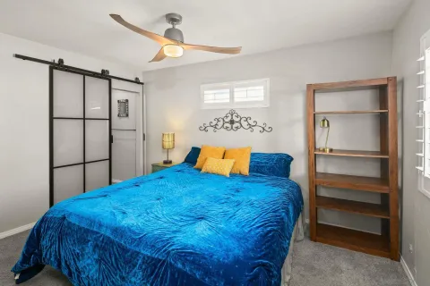 a bed sitting in a bedroom next to a window